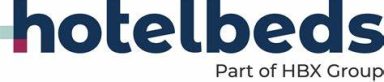 Hotelbeds logo, part of HBX Group, featuring modern typography in blue and colourful accents.